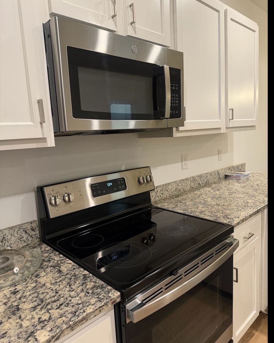 Clean kitchen with microwave and range